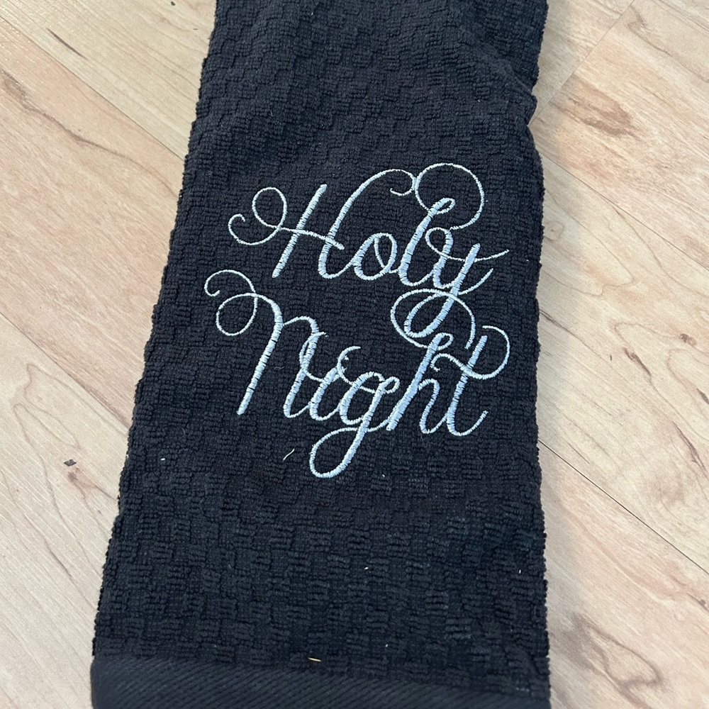 Silver embroidered Holy Night Christmas towel on black waffle weave